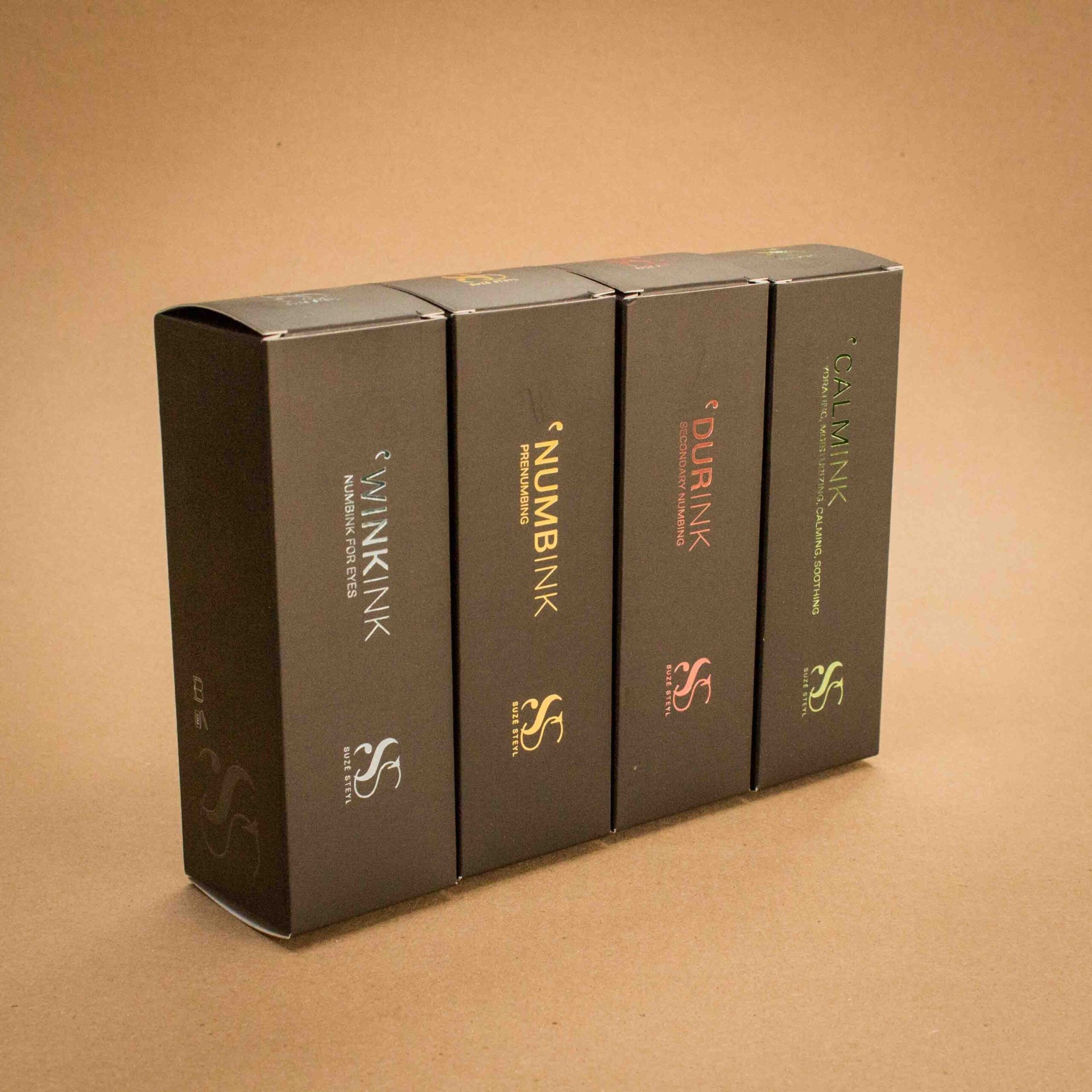 Suze Steyl Numbink tattoo aftercare range in matte black folding cartons with foil accents