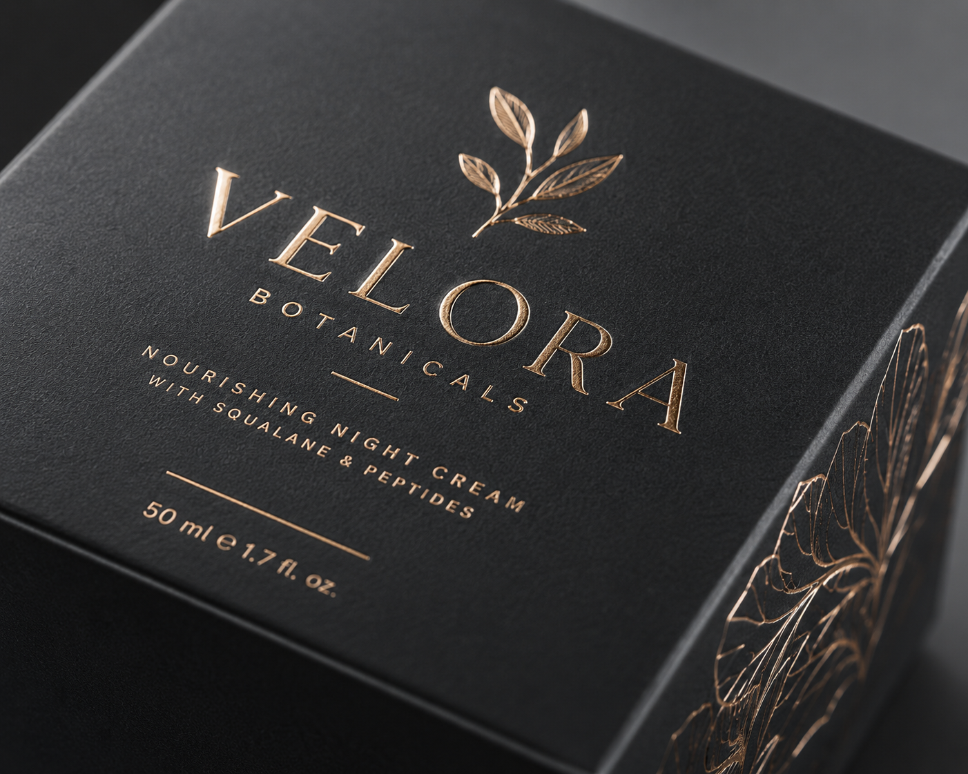 Foil stamped carton detail with embossed botanical design