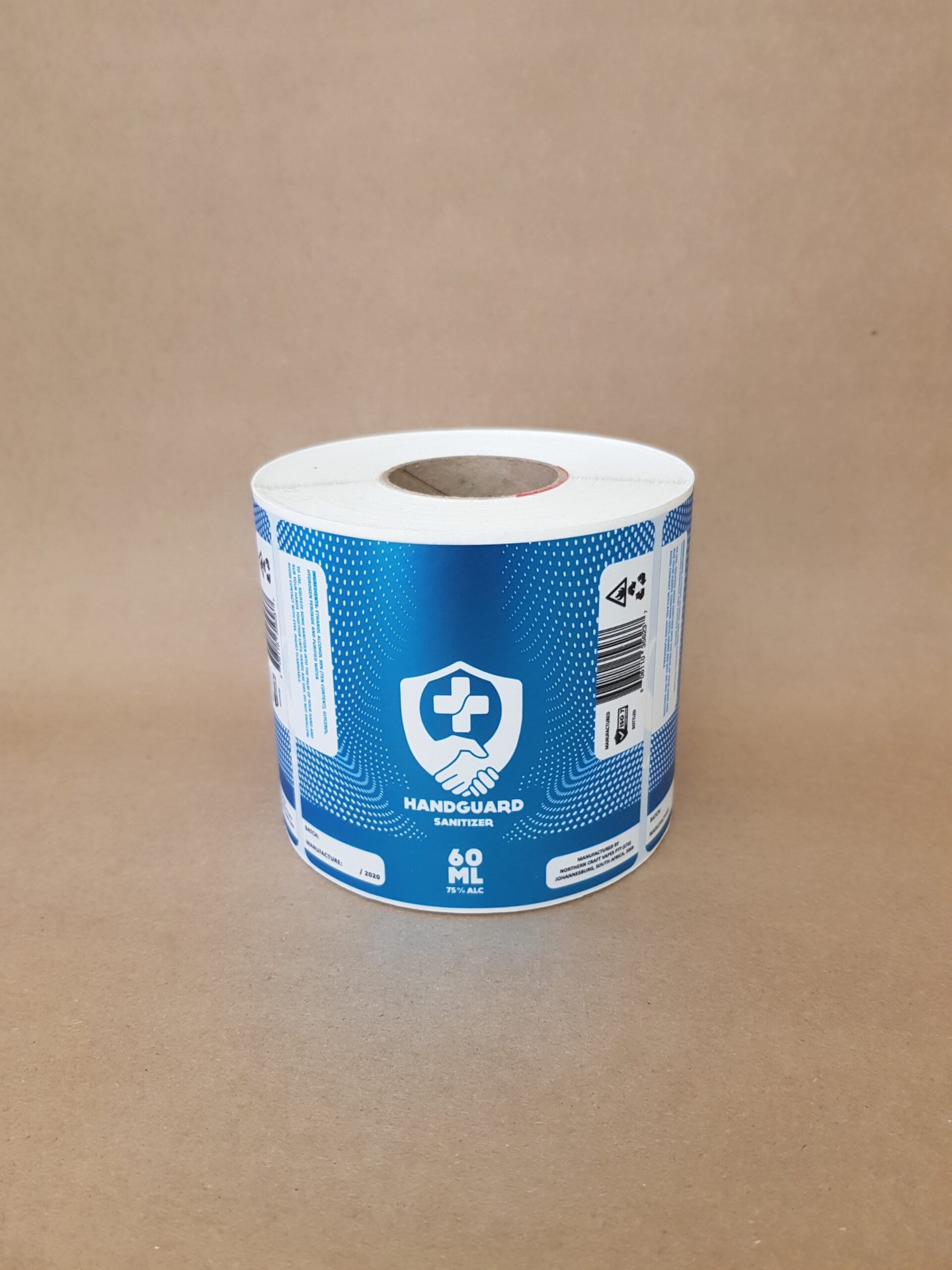 Handguard Sanitizer 60ml self-adhesive label roll in blue with shield logo